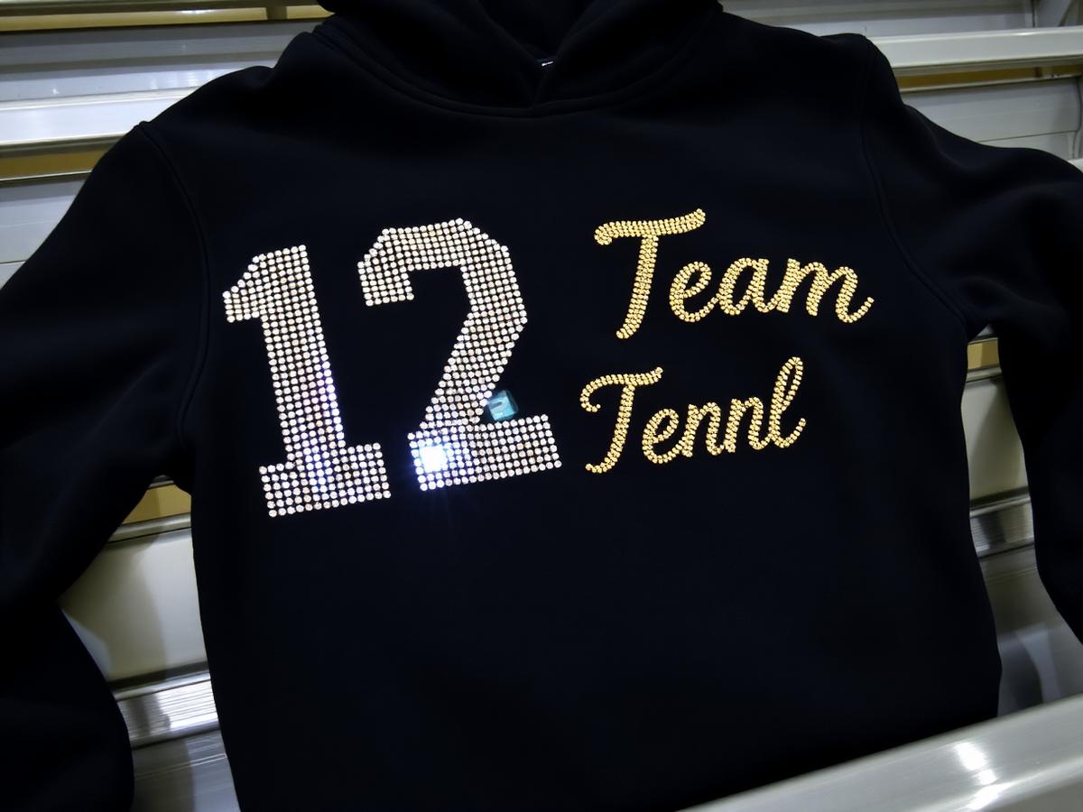 Custom rhinestone hoodie with crystal-set number for a Pittsburgh youth sports team.